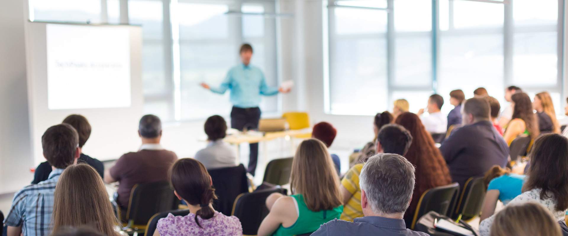 an educator standing in front od a group of students